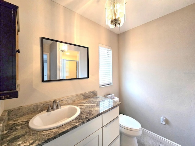 2204 34th St W, Bradenton, FL 34205 - bathroom with toilet, vanity, a chandelier, a stall shower, and baseboards