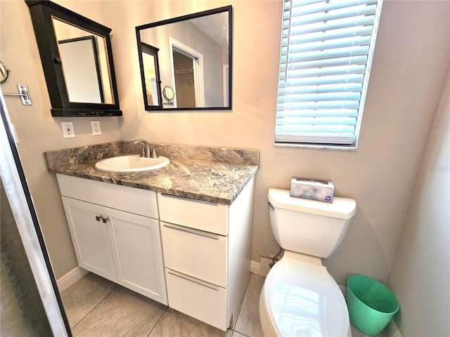 2204 34th St W, Bradenton, FL 34205 - bathroom featuring toilet, tile patterned flooring, baseboards, and vanity