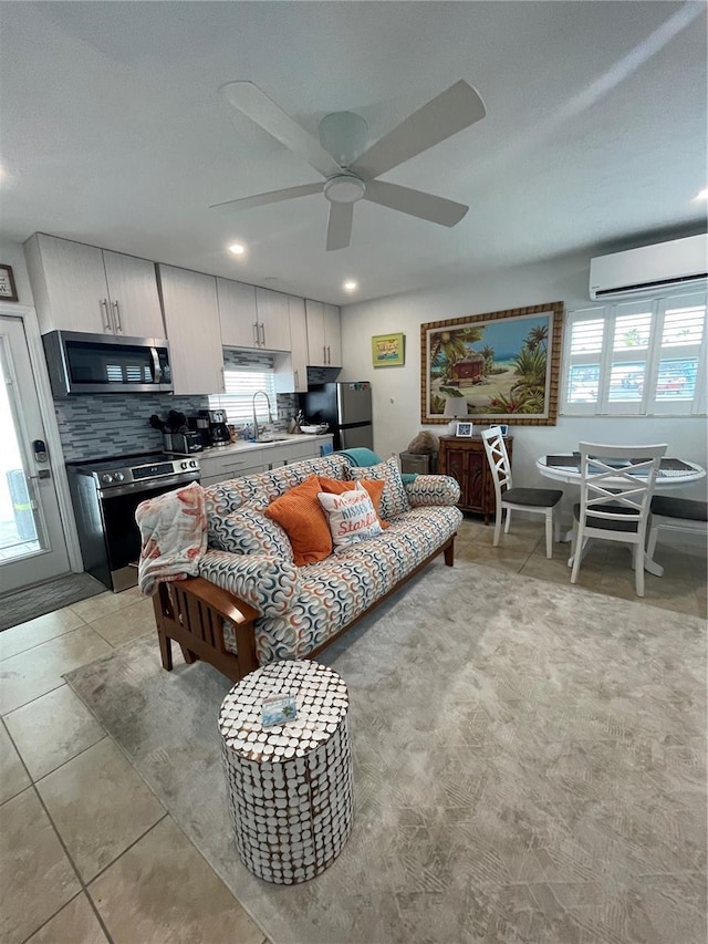 living area with recessed lighting, light tile patterned floors, a ceiling fan, and an AC wall unit