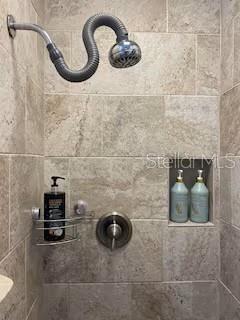 bathroom featuring tiled shower