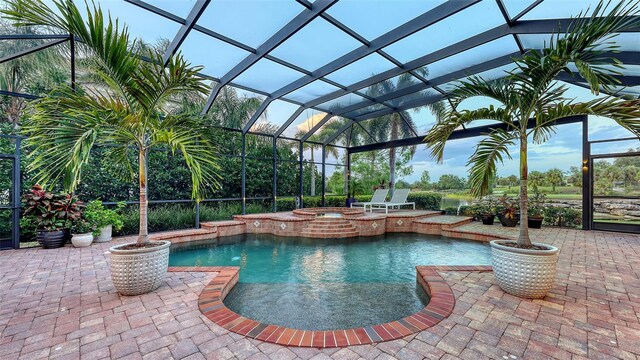 view of pool with a patio and a lanai