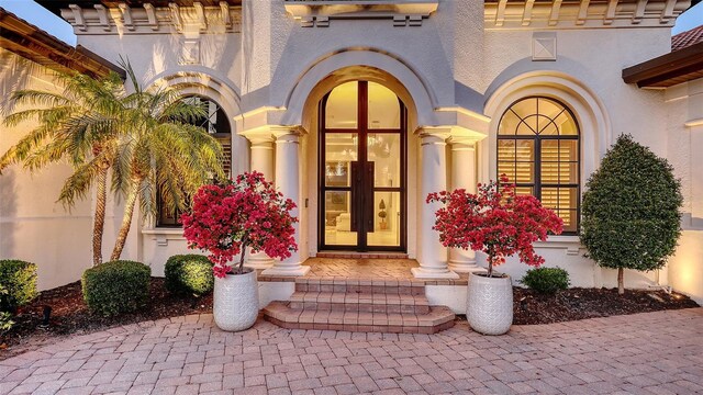 property entrance with stucco siding