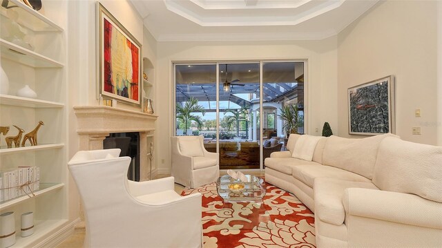 living room featuring ornamental molding and a tray ceiling
