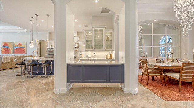 bar featuring crown molding, recessed lighting, stone tile flooring, and visible vents