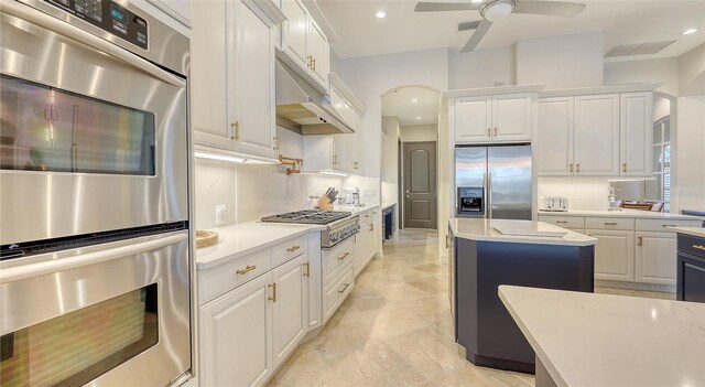 kitchen with visible vents, light countertops, under cabinet range hood, white cabinets, and stainless steel appliances