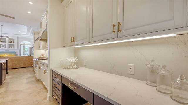 kitchen featuring white cabinets, recessed lighting, ceiling fan, and light stone counters