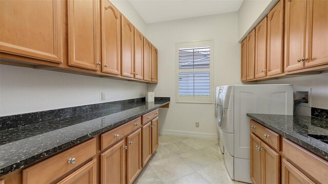 laundry area featuring cabinet space, light tile patterned floors, baseboards, and washer hookup