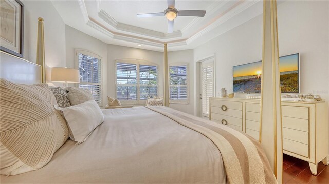 bedroom with a tray ceiling, ornamental molding, and ceiling fan