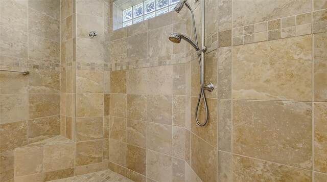 interior details with a tile shower