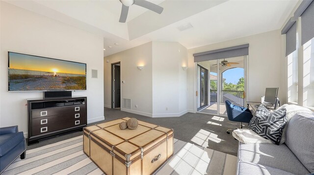 living room with light colored carpet, ceiling fan, visible vents, and baseboards