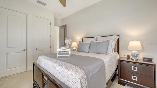 bedroom featuring light colored carpet and visible vents