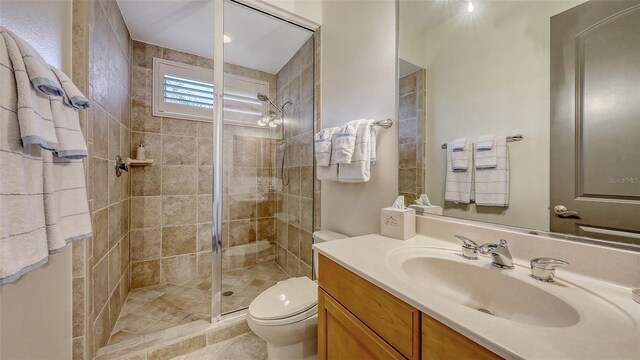 bathroom featuring vanity, a stall shower, and toilet