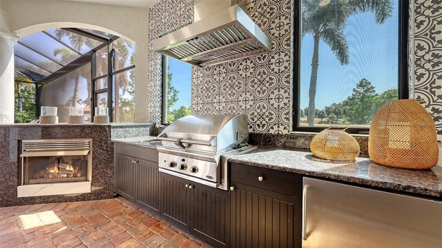 view of patio / terrace featuring an outdoor kitchen and a grill