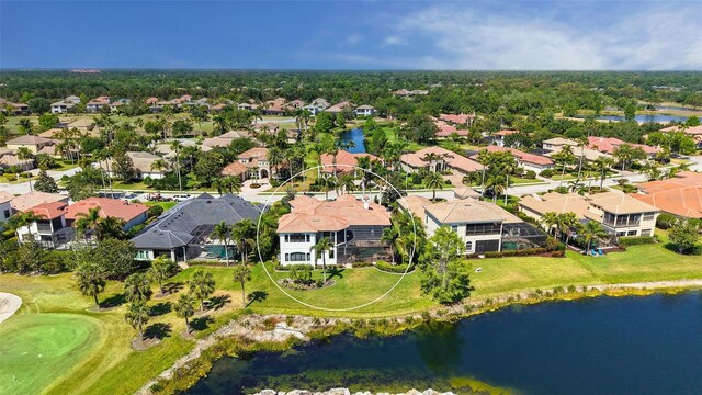 bird's eye view featuring a water view, view of golf course, and a residential view