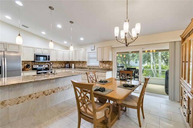 dining space featuring vaulted ceiling, a chandelier, recessed lighting, and light tile patterned flooring