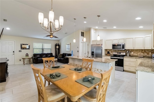 dining area with lofted ceiling, a chandelier, recessed lighting, and light tile patterned floors