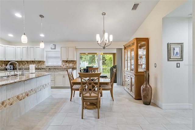 dining area with a chandelier, recessed lighting, and baseboards