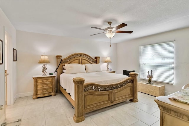 bedroom featuring baseboards, light tile patterned floors, and a ceiling fan
