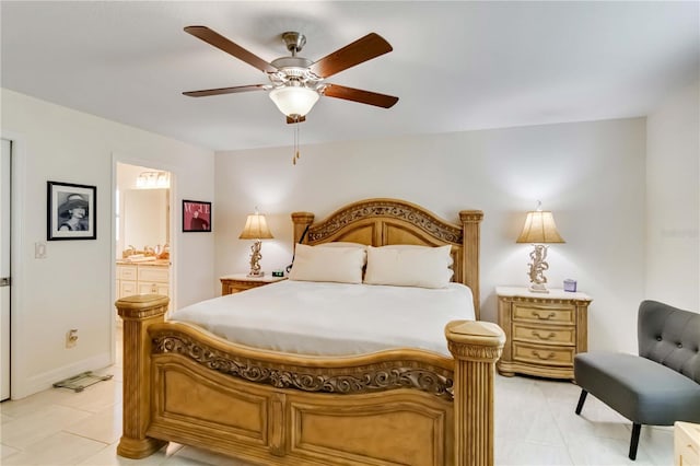 bedroom featuring connected bathroom, light tile patterned floors, ceiling fan, and baseboards