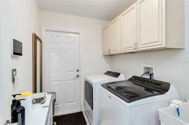 laundry room with separate washer and dryer and cabinet space