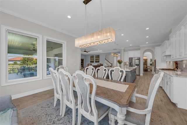 dining room with light wood finished floors, recessed lighting, baseboards, a ceiling fan, and ornamental molding