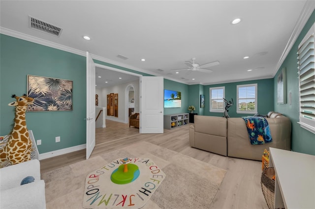 living area with recessed lighting, ornamental molding, light wood finished floors, and visible vents