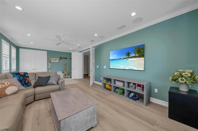 living area featuring baseboards, ornamental molding, and light wood-style flooring