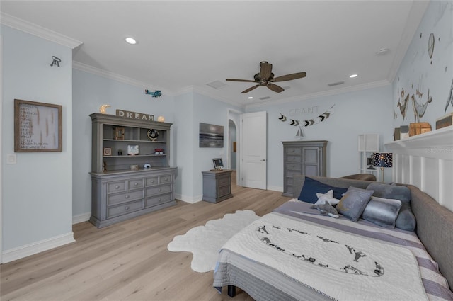 bedroom with light wood-style floors, arched walkways, ceiling fan, and recessed lighting