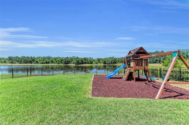 community playground featuring a water view, fence, and a yard