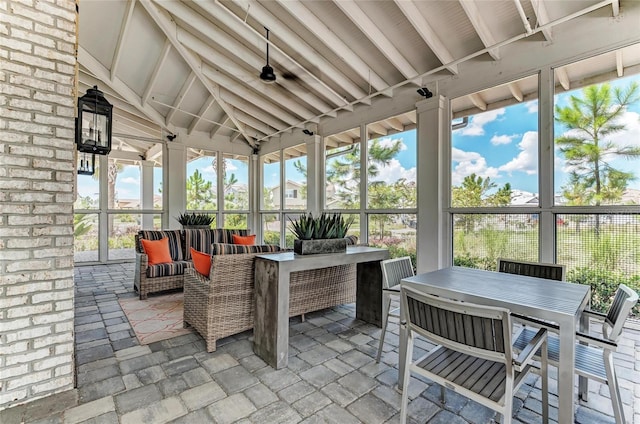 sunroom with an outdoor living space and outdoor dining space