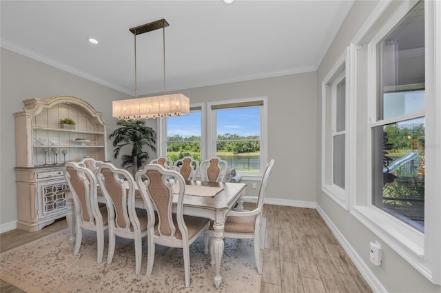 dining room featuring crown molding, baseboards, recessed lighting, and light wood-type flooring