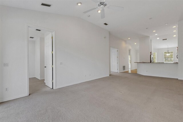 unfurnished living room with light colored carpet, ceiling fan, recessed lighting, lofted ceiling, and baseboards