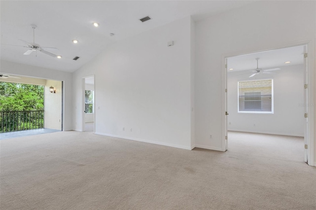 spare room featuring ceiling fan, light carpet, recessed lighting, high vaulted ceiling, and baseboards