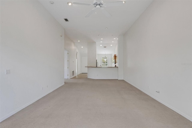 unfurnished living room featuring light colored carpet, recessed lighting, ceiling fan, and baseboards