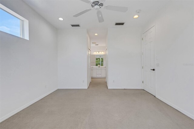 unfurnished room with light carpet, a ceiling fan, baseboards, and recessed lighting