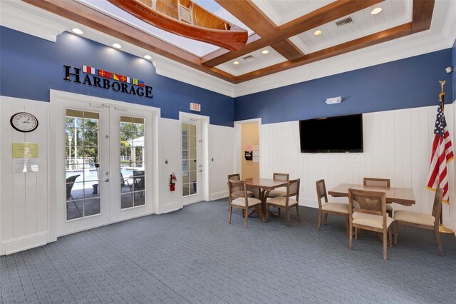 dining space featuring french doors, carpet, beamed ceiling, coffered ceiling, and a high ceiling
