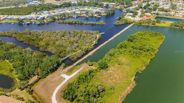 aerial view of property and surrounding area featuring a large body of water and nearby suburban area