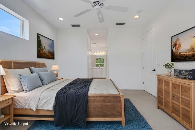 bedroom featuring light colored carpet, ensuite bath, a ceiling fan, and recessed lighting