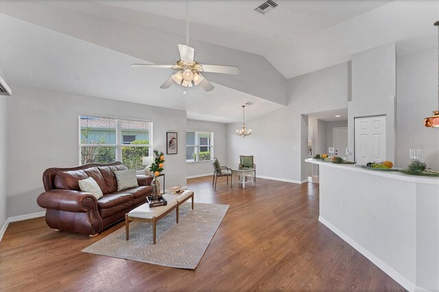 3007 Live Oak Ln, Palmetto, FL 34221 - living area featuring ceiling fan, a chandelier, baseboards, wood finished floors, and high vaulted ceiling