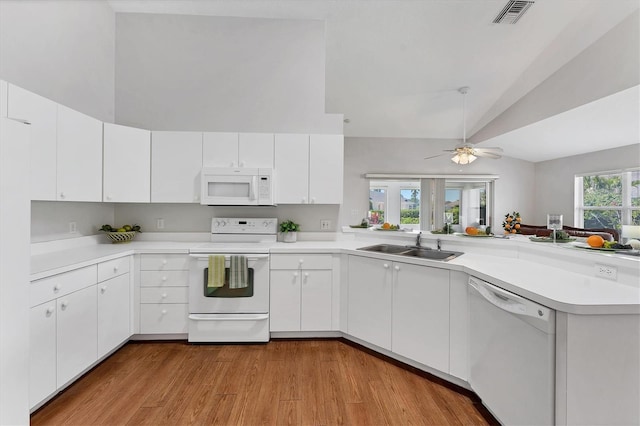 3007 Live Oak Ln, Palmetto, FL 34221 - kitchen featuring white appliances, a sink, high vaulted ceiling, a peninsula, and light countertops