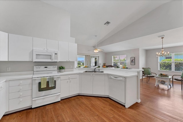 3007 Live Oak Ln, Palmetto, FL 34221 - kitchen featuring white appliances, a sink, a peninsula, light countertops, and white cabinets