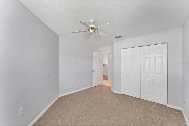 3007 Live Oak Ln, Palmetto, FL 34221 - unfurnished bedroom with carpet floors, baseboards, a closet, and a textured ceiling