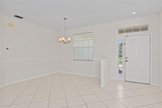 12014 Beeflower Dr, Lakewood Ranch, FL 34202 - entrance foyer featuring an inviting chandelier, baseboards, light tile patterned flooring, and visible vents