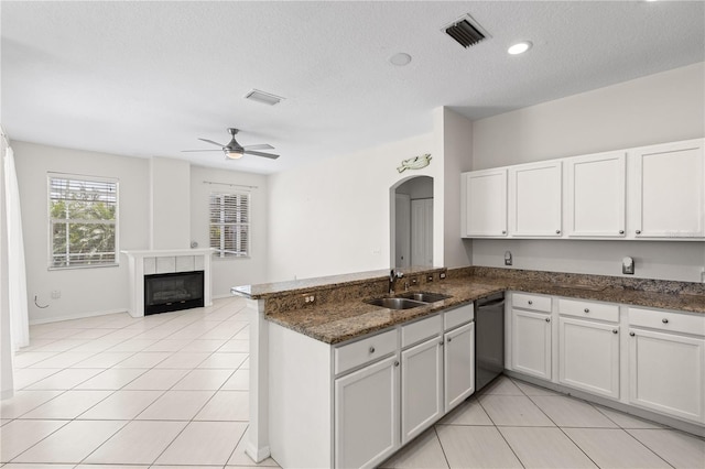 12014 Beeflower Dr, Lakewood Ranch, FL 34202 - kitchen featuring visible vents, a peninsula, light tile patterned flooring, dishwashing machine, and a sink