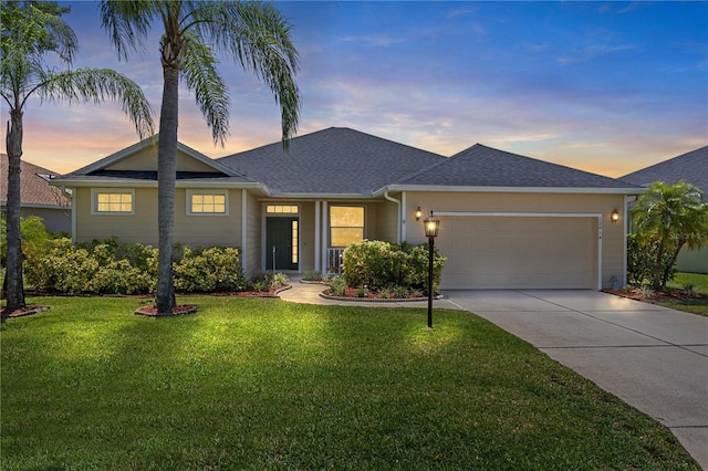 12014 Beeflower Dr, Lakewood Ranch, FL 34202 - ranch-style home with an attached garage, a shingled roof, a front lawn, and driveway