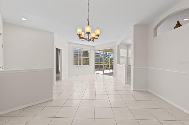 12014 Beeflower Dr, Lakewood Ranch, FL 34202 - unfurnished dining area with arched walkways, a chandelier, recessed lighting, baseboards, and light tile patterned floors