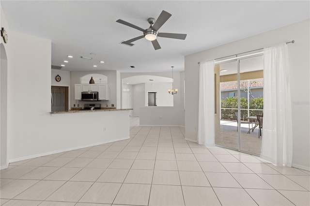 12014 Beeflower Dr, Lakewood Ranch, FL 34202 - unfurnished living room with baseboards, arched walkways, ceiling fan with notable chandelier, and visible vents