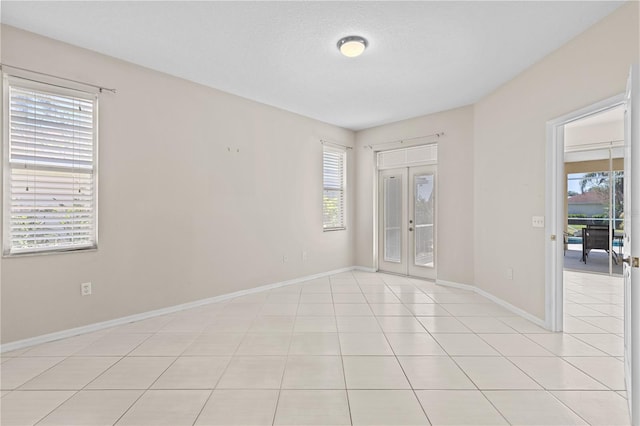 12014 Beeflower Dr, Lakewood Ranch, FL 34202 - empty room with baseboards and light tile patterned floors
