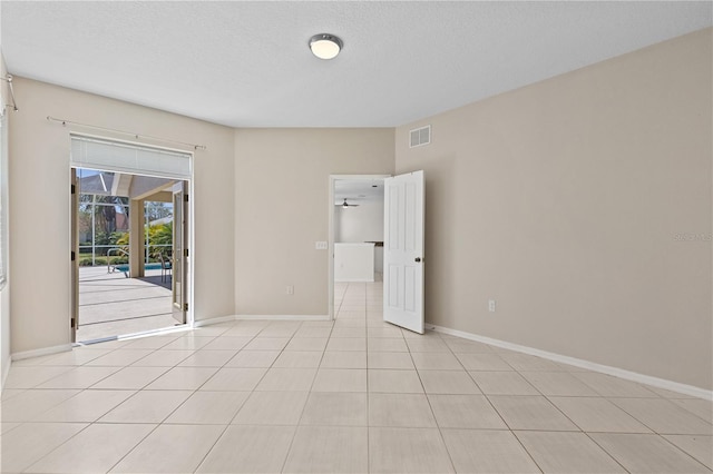 12014 Beeflower Dr, Lakewood Ranch, FL 34202 - spare room with light tile patterned floors, baseboards, a textured ceiling, and visible vents