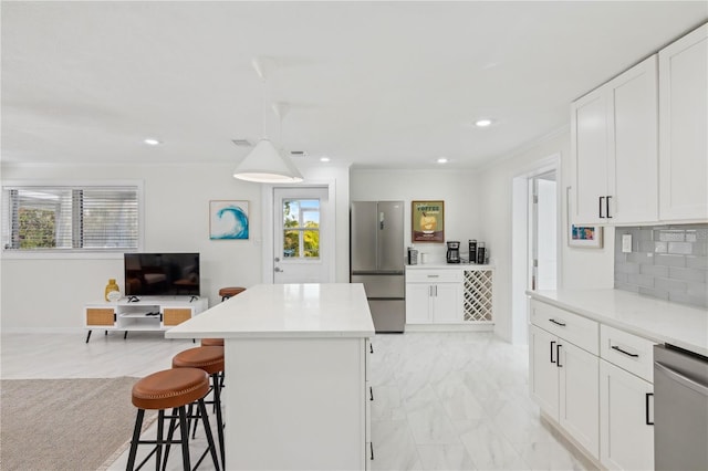 578-580 Companion Way, Longboat Key, FL 34228 - kitchen featuring a center island, a breakfast bar, white cabinets, and appliances with stainless steel finishes